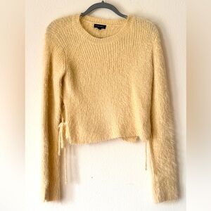 Cropped and cozy sweater with side ties.